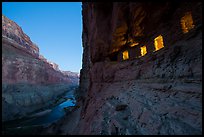 Ancient Nankoweap granaries with windows lit and Colorado River at dusk. Grand Canyon National Park, Arizona, USA.