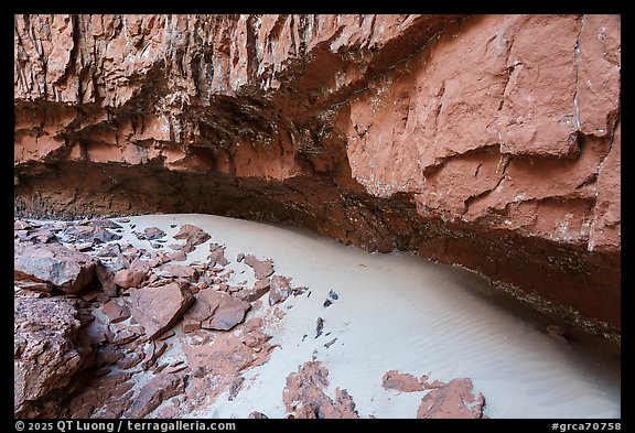 A pocket of white sand lies sheltered beneath a deep overhang of red sandstone, shaped by aeolian processes.. Grand Canyon National Park (color)