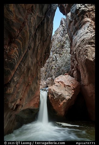 Shinumo Creek cascades into a natural plunge pool beneath towering rock walls. Grand Canyon National Park (color)