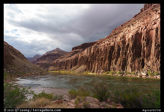 Low-angle afternoon light brushes the canyon walls while clouds gather over the Colorado River corridor. Grand Canyon National Park (color)