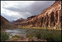 Low-angle afternoon light brushes the canyon walls while clouds gather over the Colorado River corridor. Grand Canyon National Park ( color)