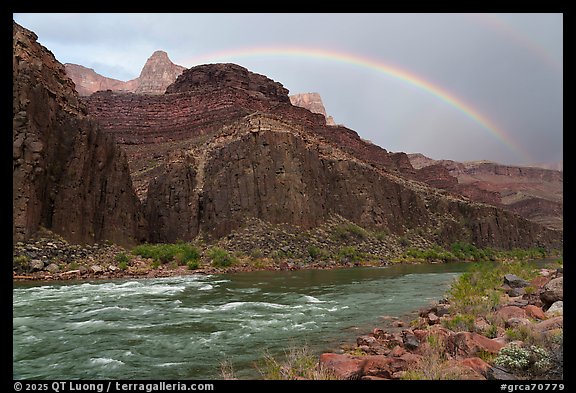 A rainbow arches above rapids after a passing storm clears the canyon skies. Grand Canyon National Park (color)