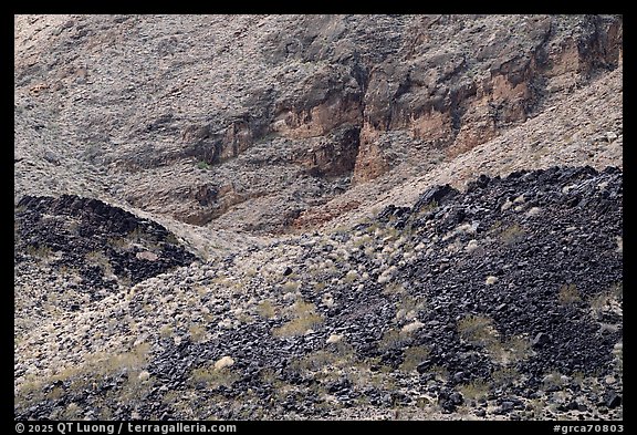 Black lava fragments spill across a pale slope of metamorphic terrain. Grand Canyon National Park (color)