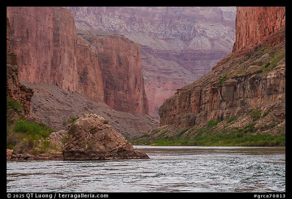 The Colorado River winds past imposing red vertical walls. Grand Canyon National Park (color)