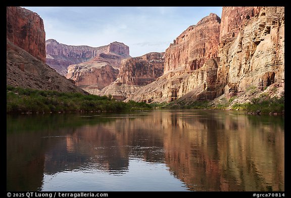 The Colorado river flows gently, framed by vividly layered canyon walls. Grand Canyon National Park (color)