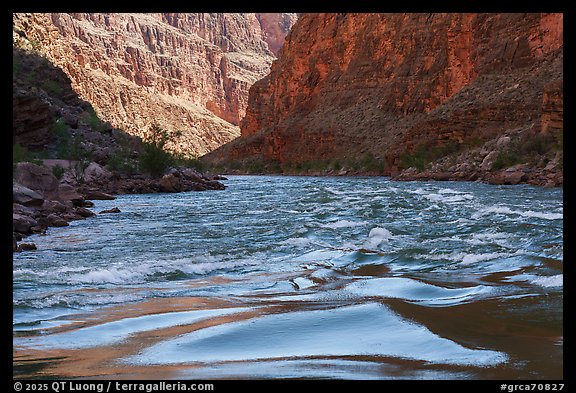 The Colorado surges through narrow walls with cliffs tinted by manganese and iron. Grand Canyon National Park (color)