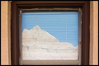 Butte, Window reflexion, Badlands National Park Headquarters. Badlands National Park, South Dakota, USA. (color)