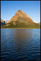 Grinnell Point across Swiftcurrent Lake, sunrise. Glacier National Park, Montana, USA.