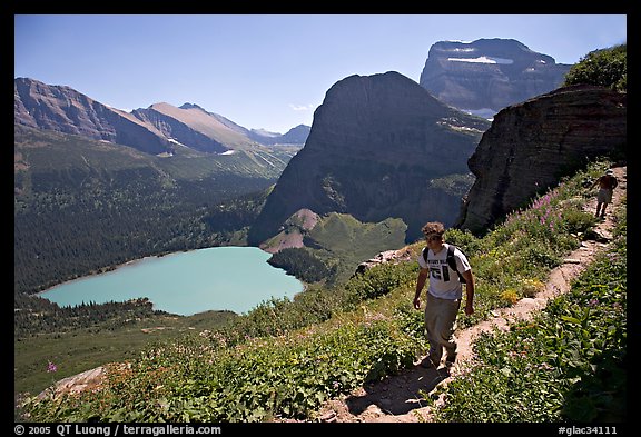 Hikers on trail overlooking Grinnell Lake. Glacier National Park (color)