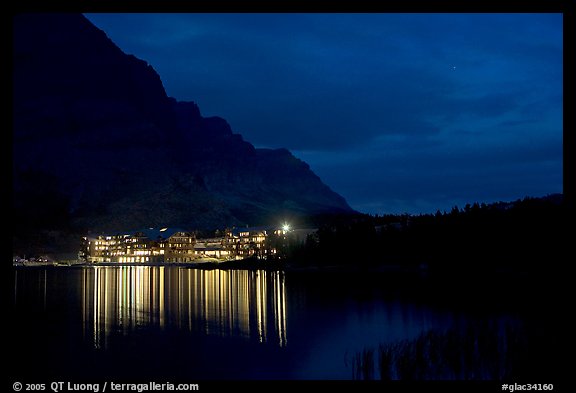 Many Glacier lodge lights reflected in Swiftcurrent Lake at night. Glacier National Park, Montana, USA.