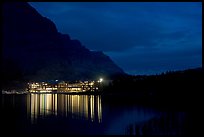 Many Glacier lodge lights reflected in Swiftcurrent Lake at night. Glacier National Park, Montana, USA. (color)