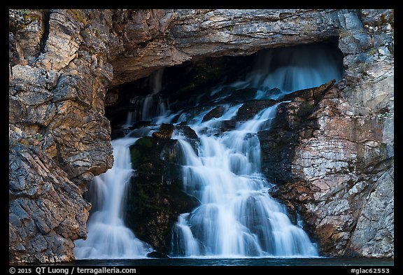 Water flows of opening in cliff face, Running Eagle Falls. Glacier National Park (color)