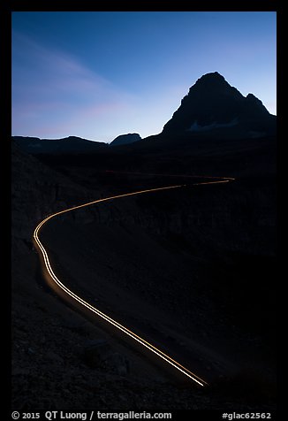 Going-to-the-Sun road at dusk with car light trail. Glacier National Park, Montana, USA.