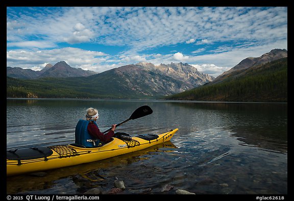 Kayaker paddles away from shore, Kintla Lake. Glacier National Park (color)