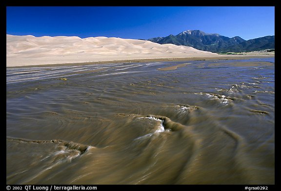 Mendonca creek with shifting sands, dunes and Sangre de Christo mountains. Great Sand Dunes National Park