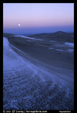 Dunes at dawn with snow and moon. Great Sand Dunes National Park and Preserve, Colorado, USA.