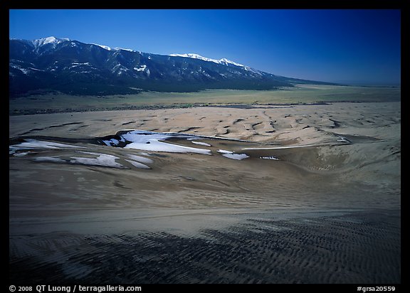 Sand dunes with patches of snow seen from above. Great Sand Dunes National Park, Colorado, USA.