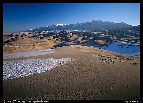 Sand dunes with snow patches and Sangre de Christo range. Great Sand Dunes National Park and Preserve, Colorado, USA.