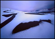 Patch of sand in snow-covered dunes at dawn. Great Sand Dunes National Park ( color)