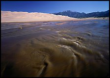Medano creek with shifting sands, dunes and Sangre de Christo mountains. Great Sand Dunes National Park and Preserve, Colorado, USA.