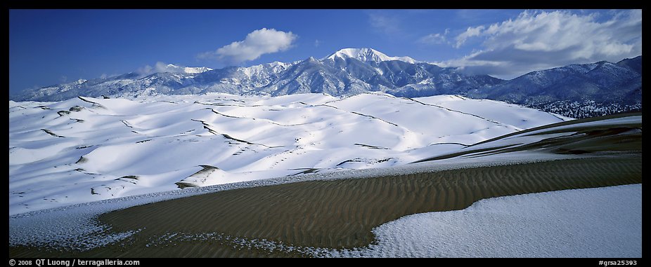 Landscape of snowy dunes and mountains. Great Sand Dunes National Park and Preserve, Colorado, USA.