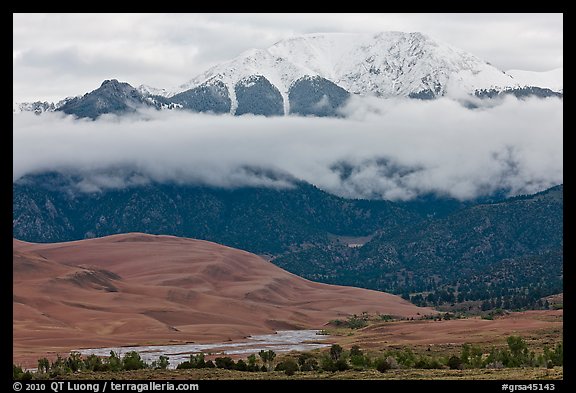 Dunes and Medano creek below snowy mountains. Great Sand Dunes National Park and Preserve (color)