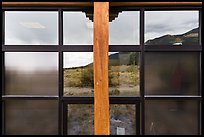 Grasslands and mountains, visitor center window reflexion. Great Sand Dunes National Park, Colorado, USA. (color)