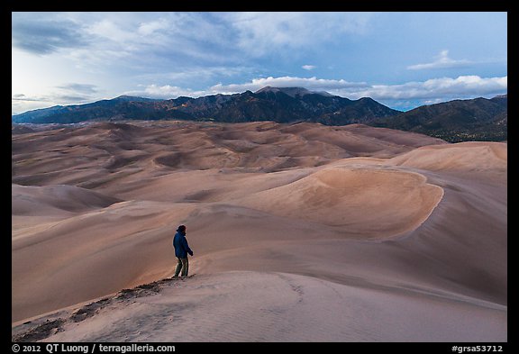 Park visitor looking, dune field. Great Sand Dunes National Park, Colorado, USA.