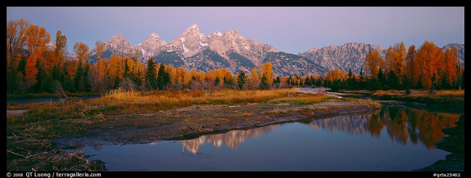 Jagged mountains and autumn colors reflected at sunrise. Grand Teton National Park, Wyoming, USA.