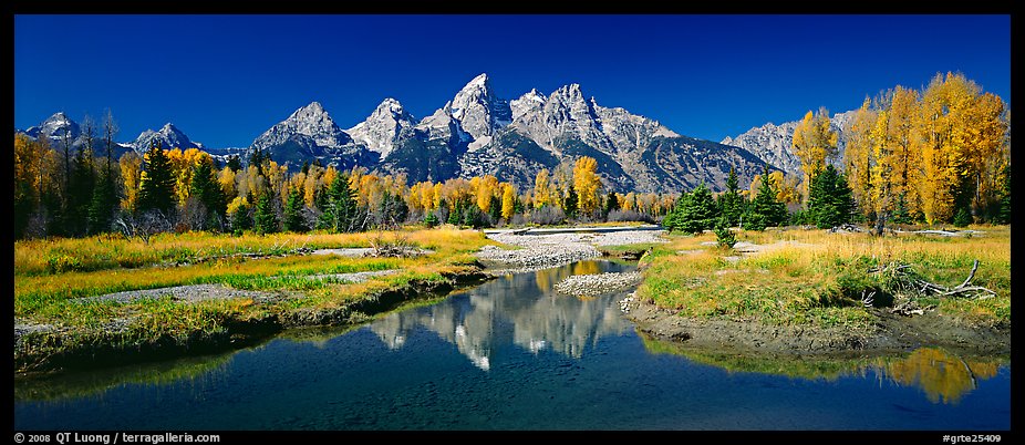 Mountains and fall colors reflected in pond, Schwabacher Landing. Grand Teton National Park, Wyoming, USA.