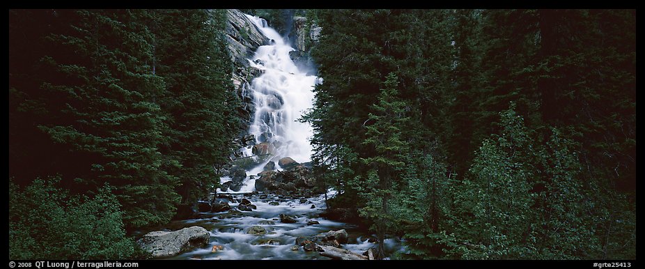 Waterfall flowing in dark forest. Grand Teton National Park, Wyoming, USA.