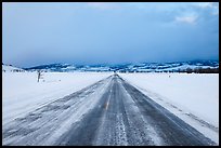 Road in winter at dusk, Gross Ventre valley. Grand Teton National Park, Wyoming, USA.