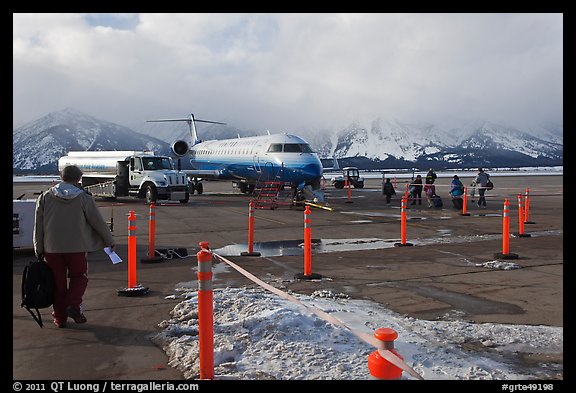 Passengers walking towards plane on Jackson Hole Airport. Grand Teton National Park (color)