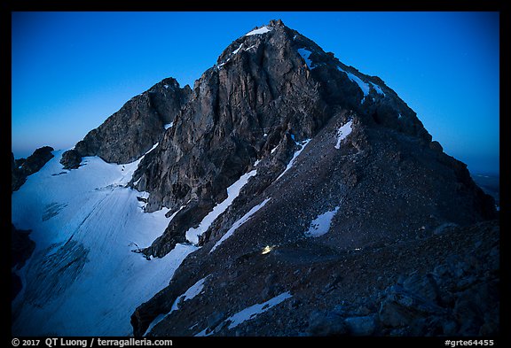 Middle Teton at night, with lights from climbers approaching. Grand Teton National Park, Wyoming, USA.