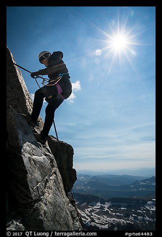 Woman climber rappelling on Grand Teton. Grand Teton National Park, Wyoming, USA.