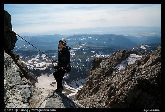 Woman climber rappels from Grand Teton. Grand Teton National Park, Wyoming, USA.