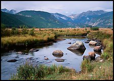 Creek, boulders, and meadow surrounded by mountains, autumn. Rocky Mountain National Park, Colorado, USA.