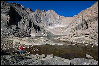 Park visitor Looking, Chasm Lake. Rocky Mountain National Park, Colorado, USA. (color)