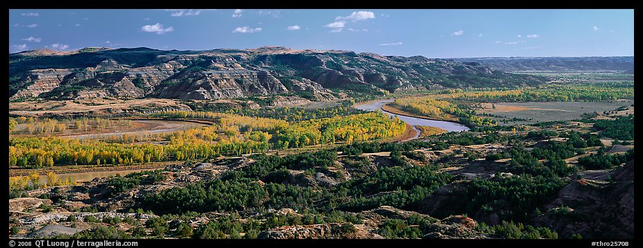 Wide valley with river and aspens in autumn color. Theodore Roosevelt National Park, North Dakota, USA.