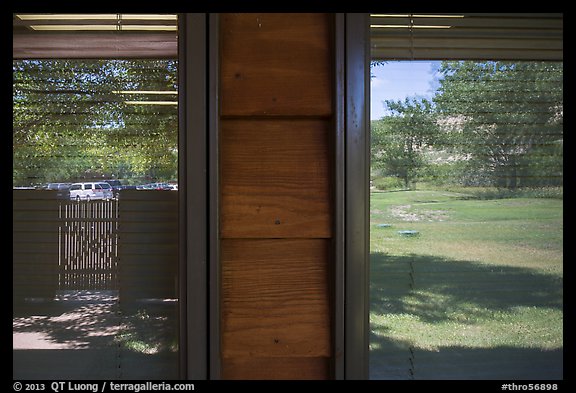 Meadow and parking lot, Medora Visitor Center window reflexion. Theodore Roosevelt National Park, North Dakota, USA.