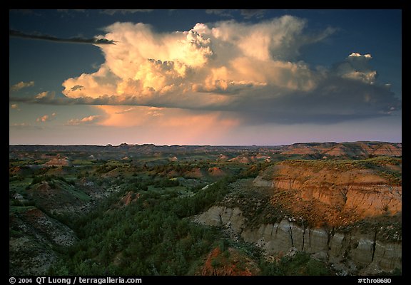 Storm cloud and badlands at sunset, South Unit. Theodore Roosevelt National Park, North Dakota, USA.