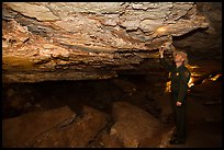 Ranger pointing at speleotherm in large cave room. Wind Cave National Park ( color)
