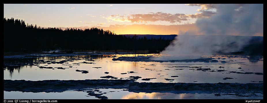 Steam rising in geyser pool at sunset. Yellowstone National Park, Wyoming, USA.