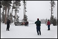 Tourists take pictures with entrance sign in winter. Yellowstone National Park ( color)