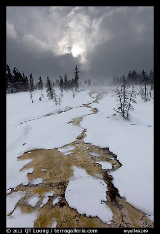 Colorful thermal stream and dark clouds, winter. Yellowstone National Park (color)