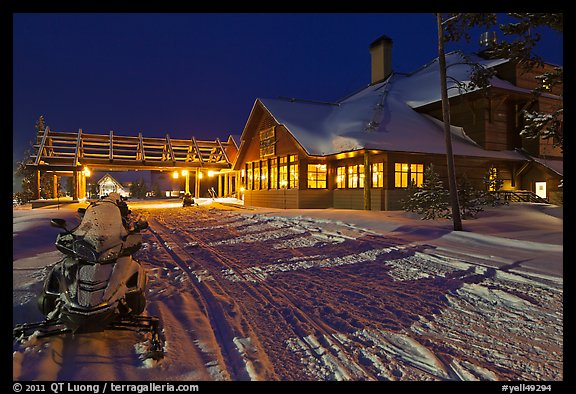 Snowmobiles parked next to Old Faithful Snow Lodge at night. Yellowstone National Park (color)