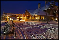 Snowmobiles parked next to Old Faithful Snow Lodge at night. Yellowstone National Park ( color)
