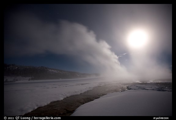 Run-off and geyser, steam obscuring moon, Old Faithful. Yellowstone National Park, Wyoming, USA.