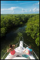 Passengers on front of boat navigating narrow channel. Biscayne National Park ( color)