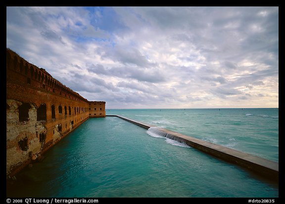 Fort Jefferson wall and moat with wave over seawall, cloudy weather. Dry Tortugas  National Park (color)